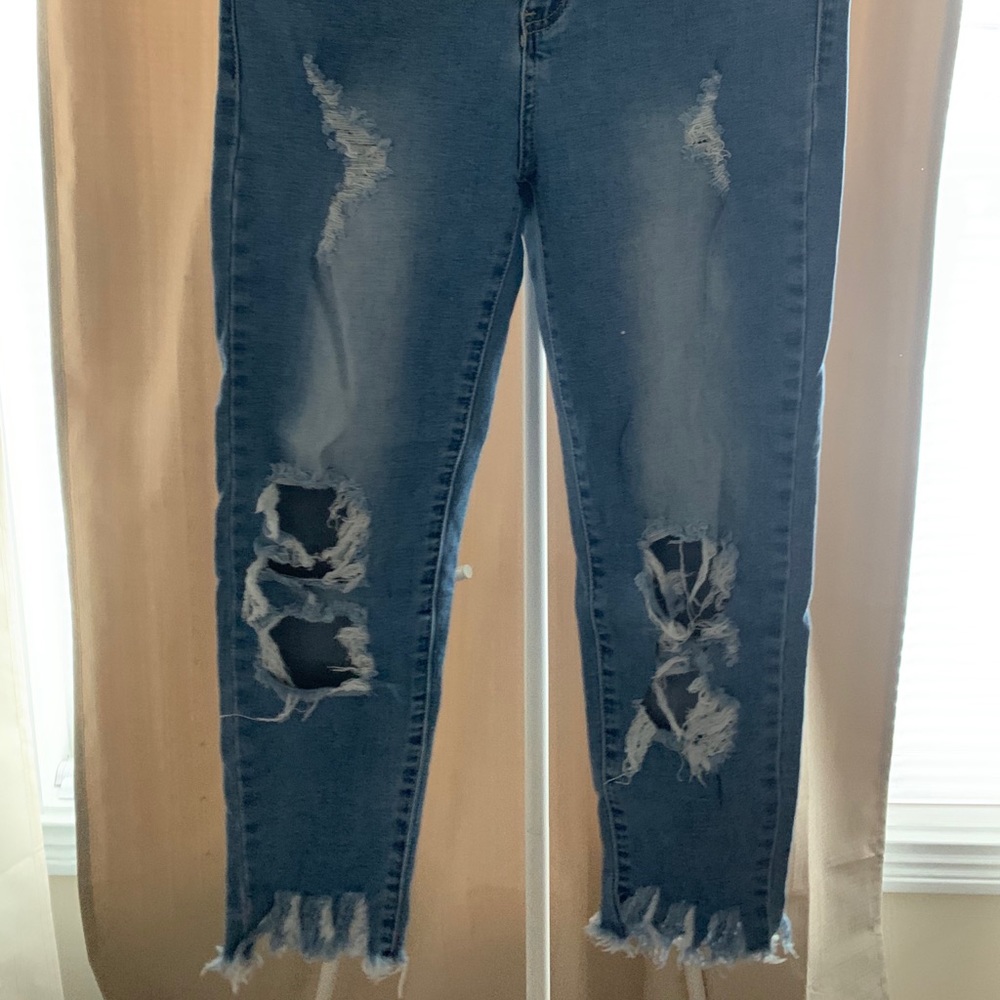 Light blue distressed jeans with frayed bottom